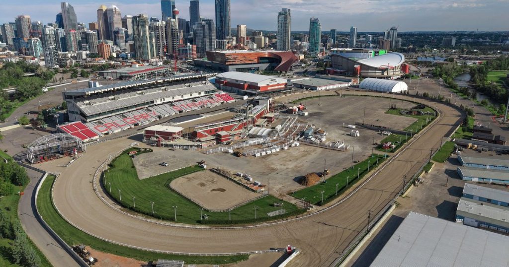 Aerial view of GMC Stadium and the racetrack at Stampede Park, with downtown Calgary behind