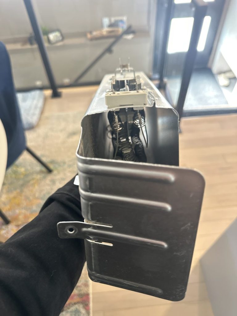 Shorted heater case assembly removed from a Samsung dryer during a Calgary repair